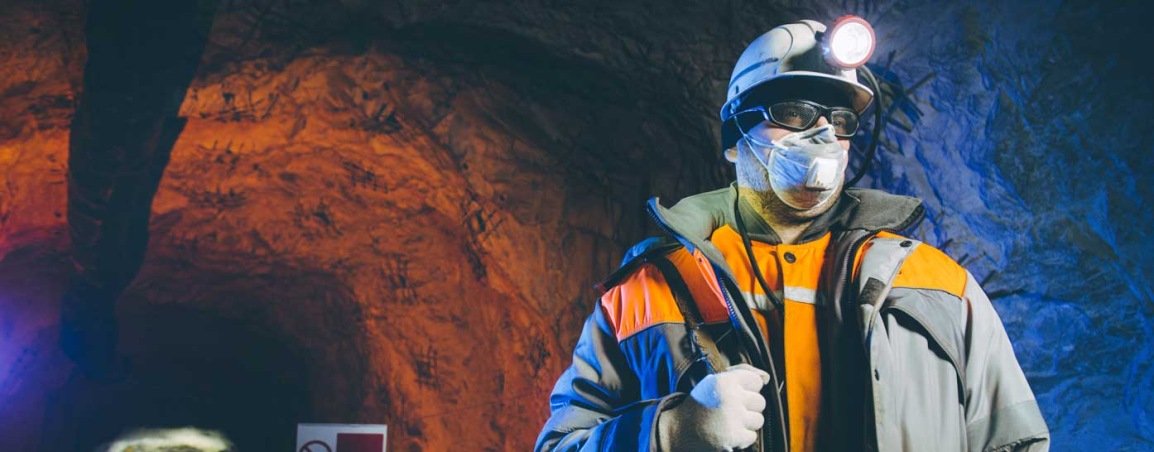 Industrial worker with a hard hat wearing a face mask